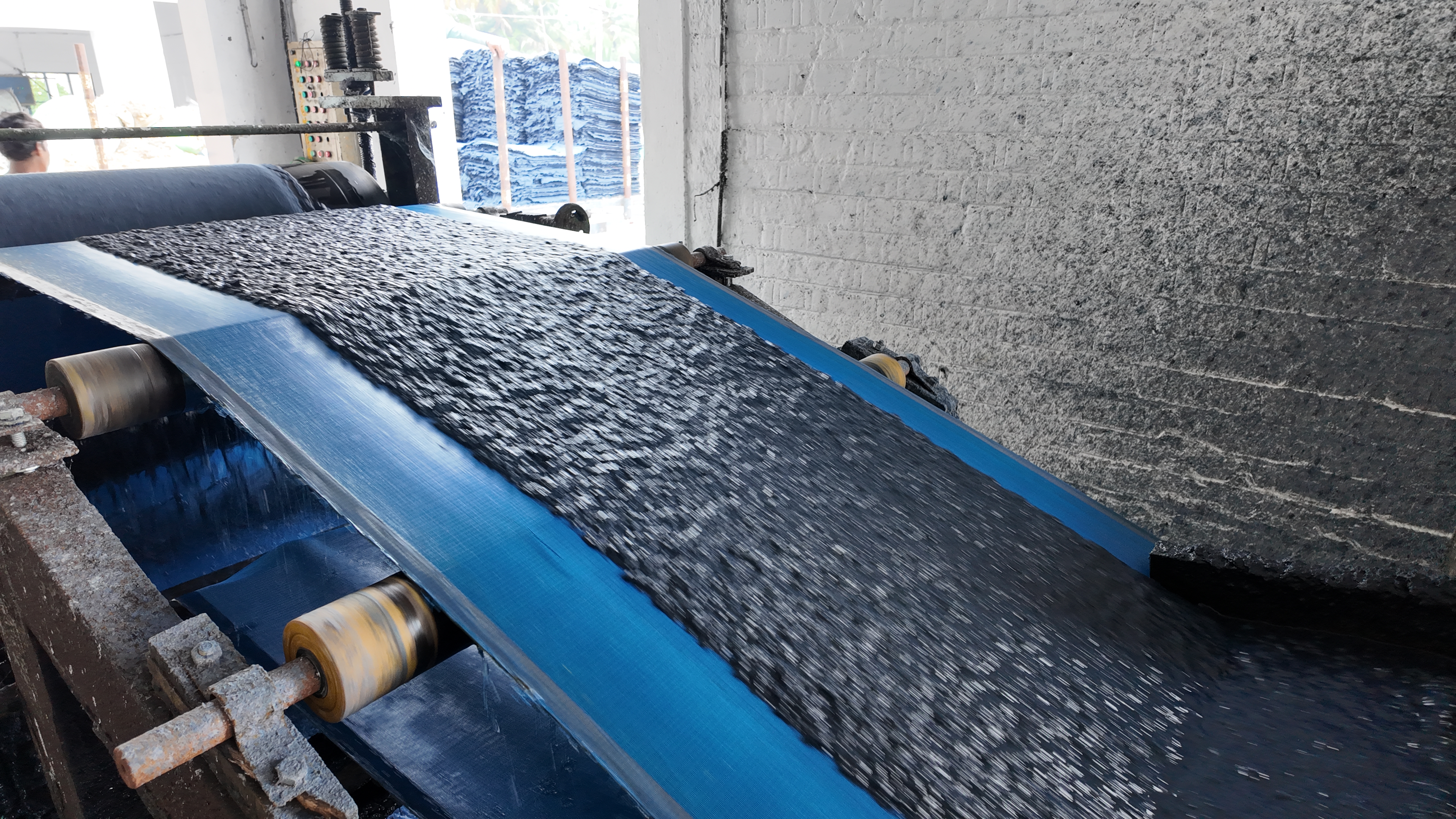 Production conveyor carrying processed pulp material.